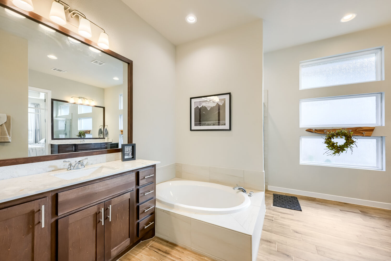 621 Rancho Sienna Loop Georgetown, TX 78628 - Photo 16 of 28 Luxurious soaking tub and well-lit vanity create a serene primary bathroom retreat.