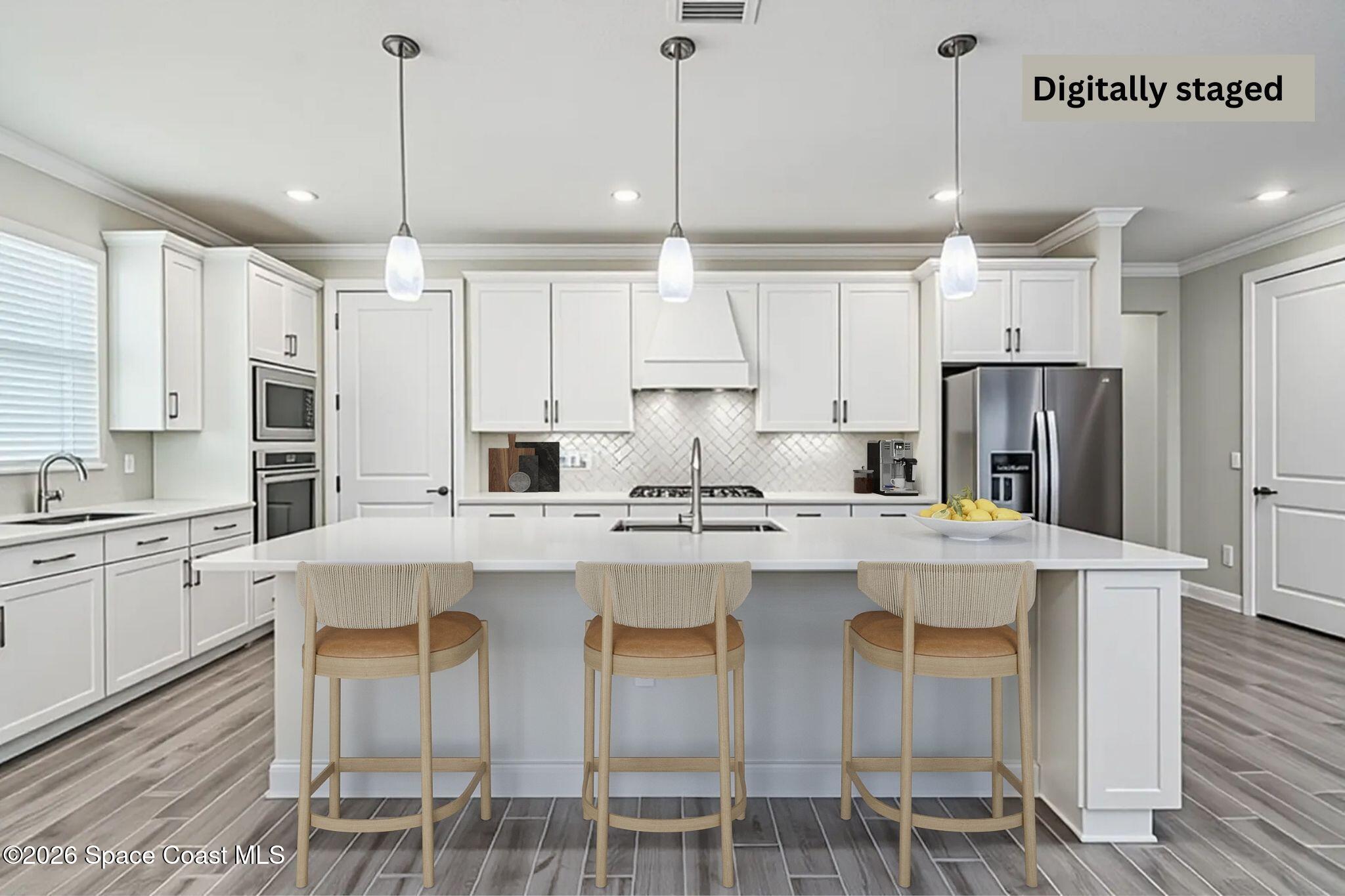 3032 Tidepool Place Melbourne, FL 32940 - Photo 11 of 67 a kitchen with stainless steel appliances kitchen island granite countertop a table chairs stove and refrigerator