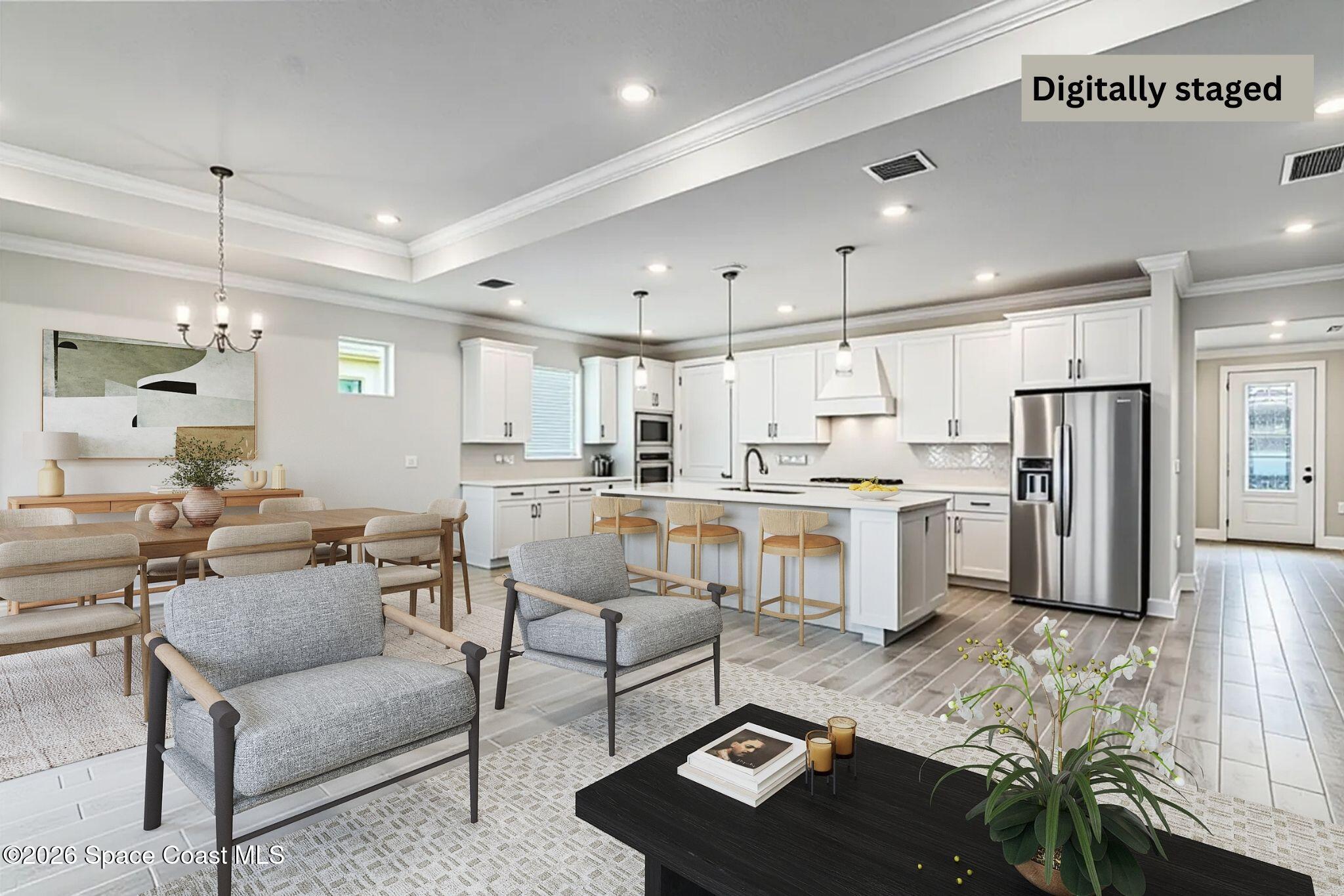 3032 Tidepool Place Melbourne, FL 32940 - Photo 13 of 67 a kitchen with stainless steel appliances kitchen island granite countertop a refrigerator a stove a sink a dining table and chairs with wooden floor