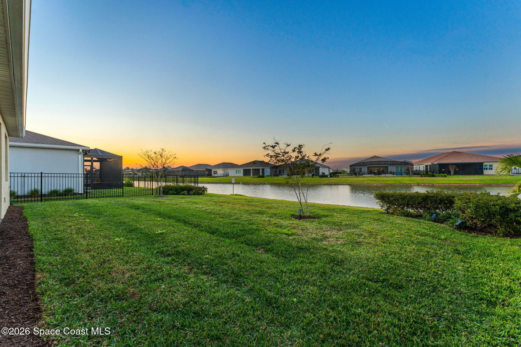 3032 Tidepool Place Melbourne, FL 32940 - Photo 2 of 67 a view of a golf course with a lake