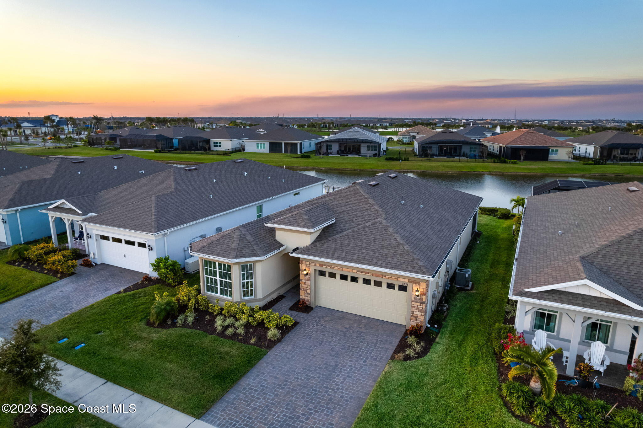 3032 Tidepool Place Melbourne, FL 32940 - Photo 37 of 67 an aerial view of a house with a garden and lake view