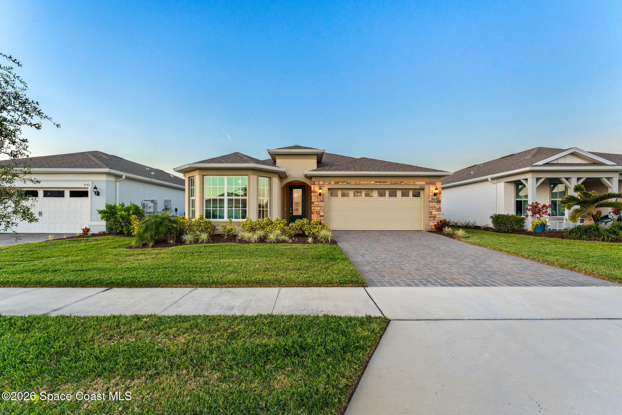 3032 Tidepool Place Melbourne, FL 32940 - Photo 56 of 67 a front view of a house with a yard and garage