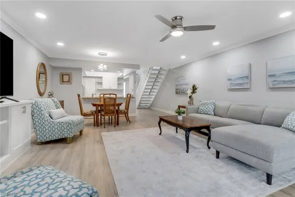 a living room with furniture and kitchen view