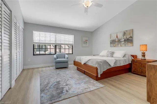 a bedroom with a bed and a couch with window