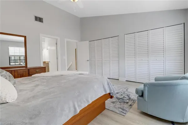 a bedroom with a bed and a couch