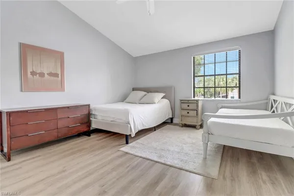 a spacious bedroom with a bed and a window