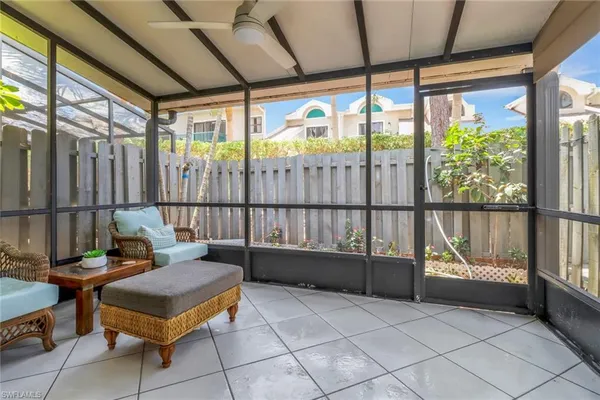 a living room with a large window and furniture