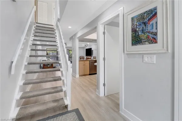 a view of an entryway with wooden floor