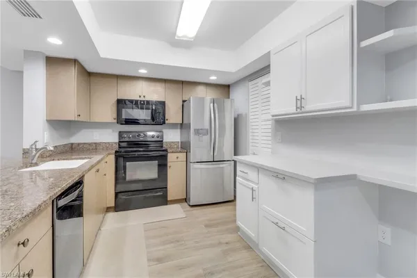 a kitchen with a sink stove and refrigerator