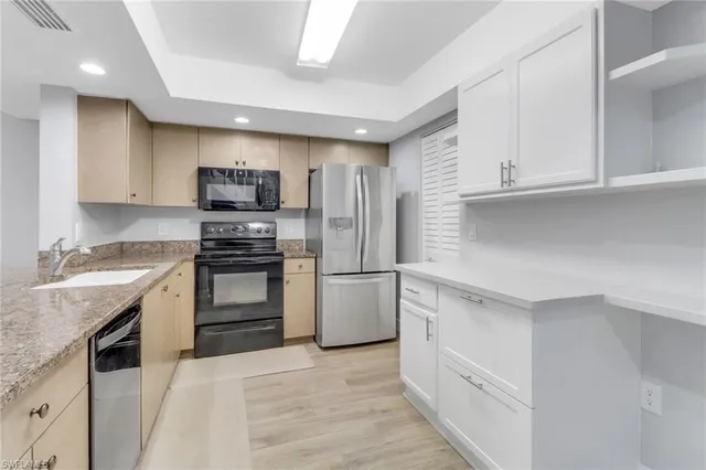 a kitchen with a sink stove and refrigerator