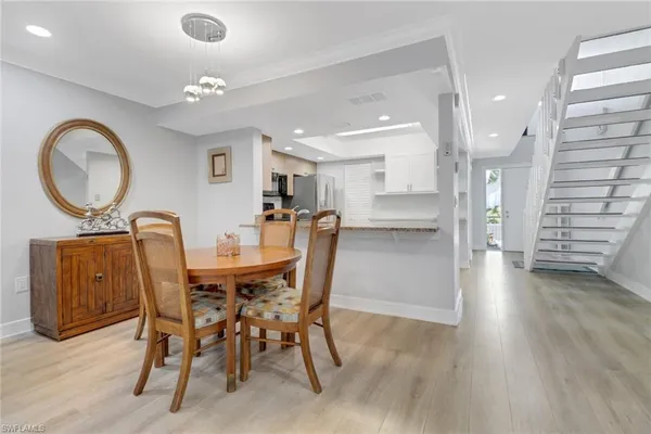 a dining room with furniture and wooden floor