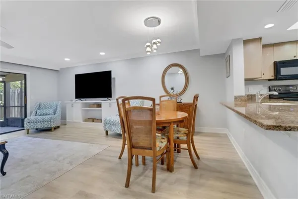 a view of a dining room with furniture and a flat screen tv