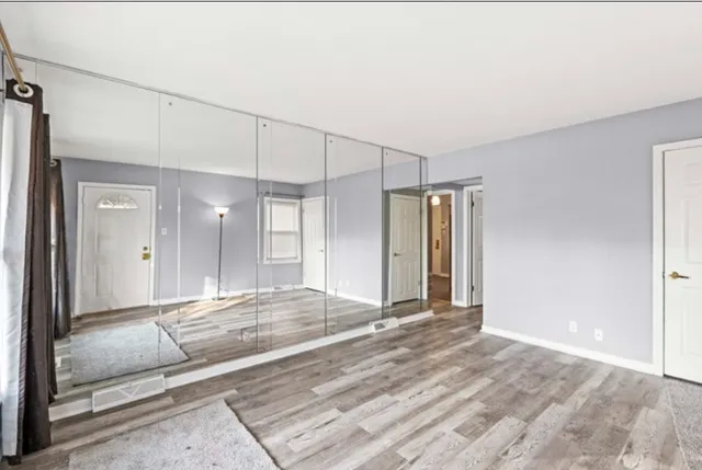 a view of a room with wooden floor and bathroom