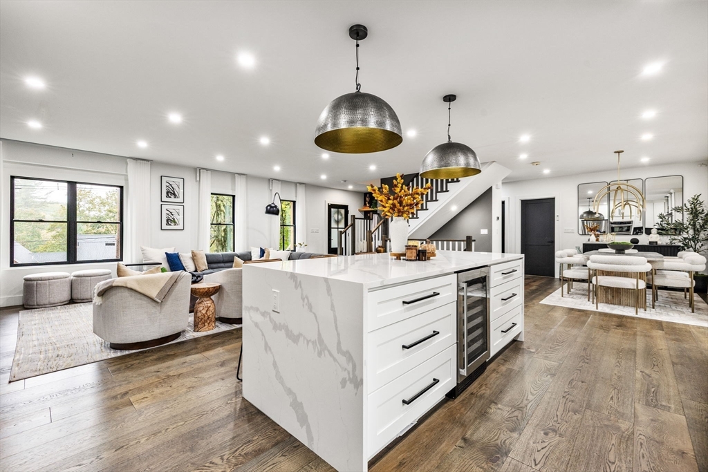 973 Main Street Lynnfield, MA 01940 - Photo 1 of 37 a kitchen with stainless steel appliances granite countertop a stove oven a dining table and chairs with wooden floor