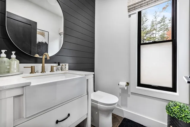 a bathroom with a toilet sink and mirror
