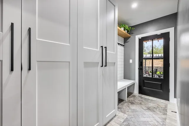a bedroom with a large bed and a chandelier