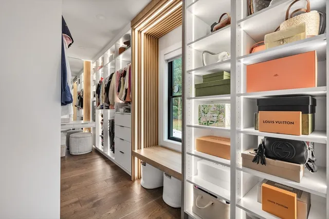 a bathroom with a double vanity sink a toilet a mirror and shower