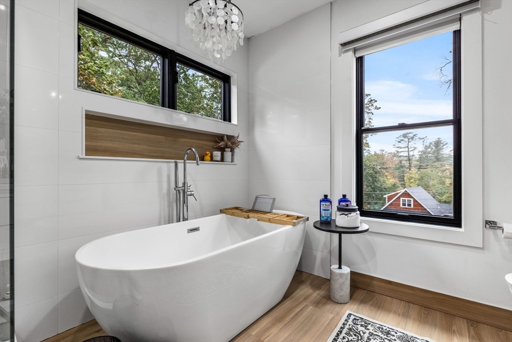 973 Main Street Lynnfield, MA 01940 - Photo 18 of 37 a white bath tub sitting next to a window