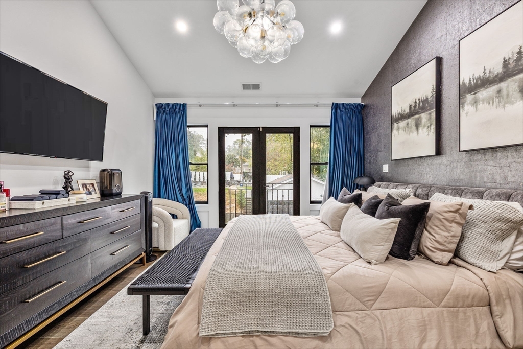 973 Main Street Lynnfield, MA 01940 - Photo 20 of 37 a bedroom with a large bed and a flat tv screen on dresser