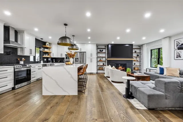 a living room with fireplace furniture and a wooden floor