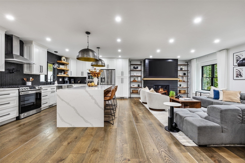 973 Main Street Lynnfield, MA 01940 - Photo 2 of 37 a living room with fireplace furniture and a wooden floor