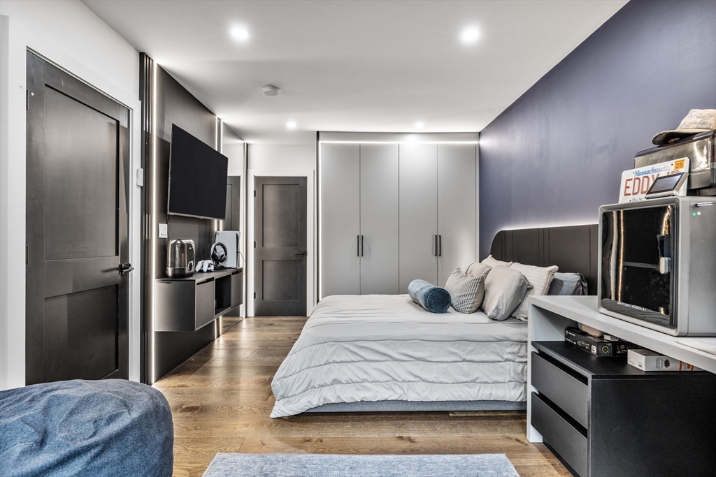 973 Main Street Lynnfield, MA 01940 - Photo 23 of 37 a large bedroom with a bed and a refrigerator