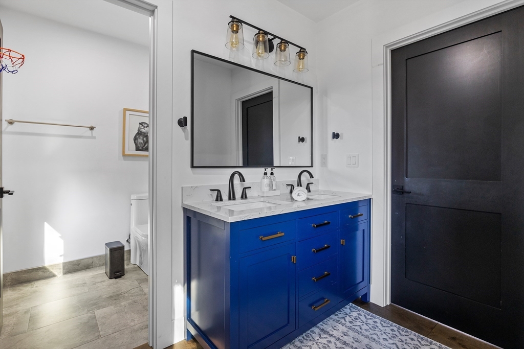 973 Main Street Lynnfield, MA 01940 - Photo 24 of 37 a bathroom with a sink and a mirror