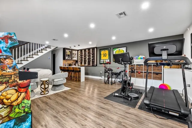 a living room with furniture kitchen view and a large window