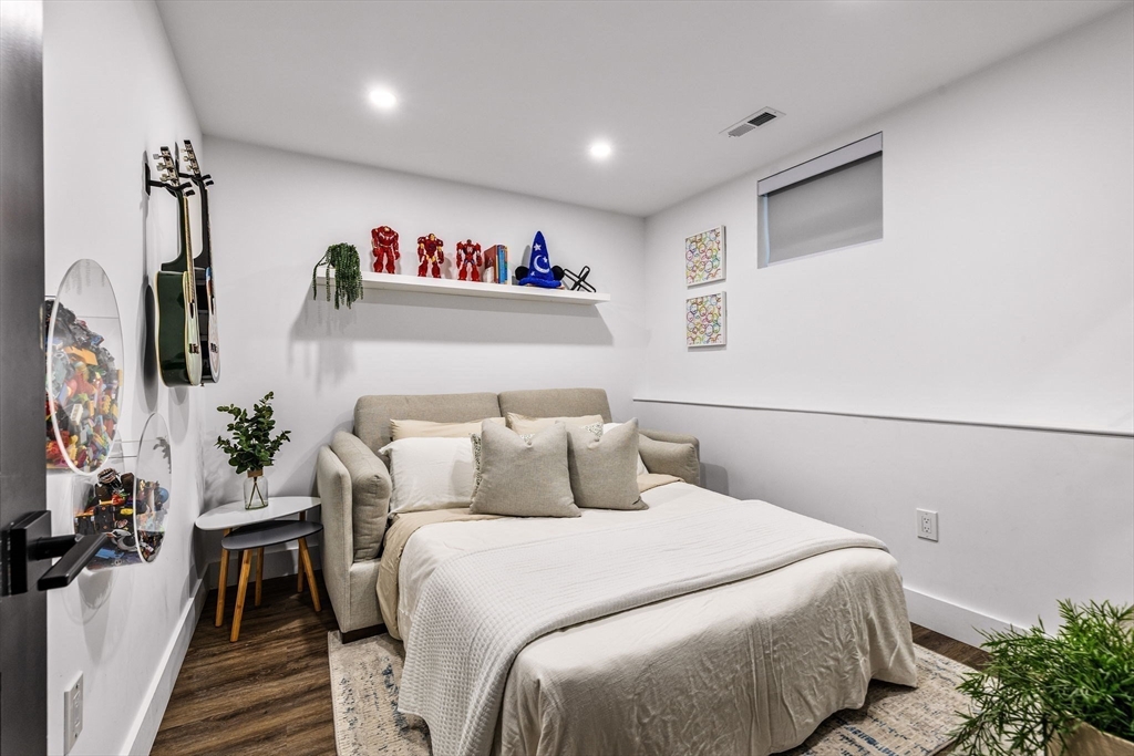 973 Main Street Lynnfield, MA 01940 - Photo 31 of 37 a bedroom with a bed and a flat screen tv
