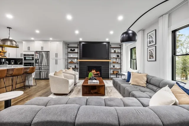 a living room with furniture fireplace and a flat screen tv