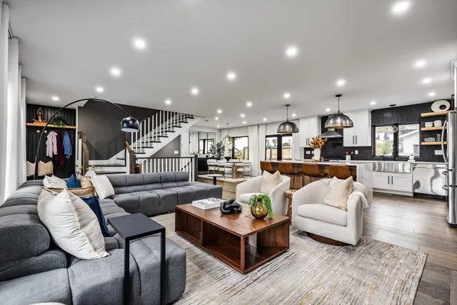 a living room with furniture and kitchen view