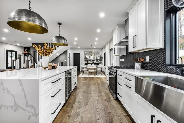 a kitchen with stainless steel appliances granite countertop a sink and stove
