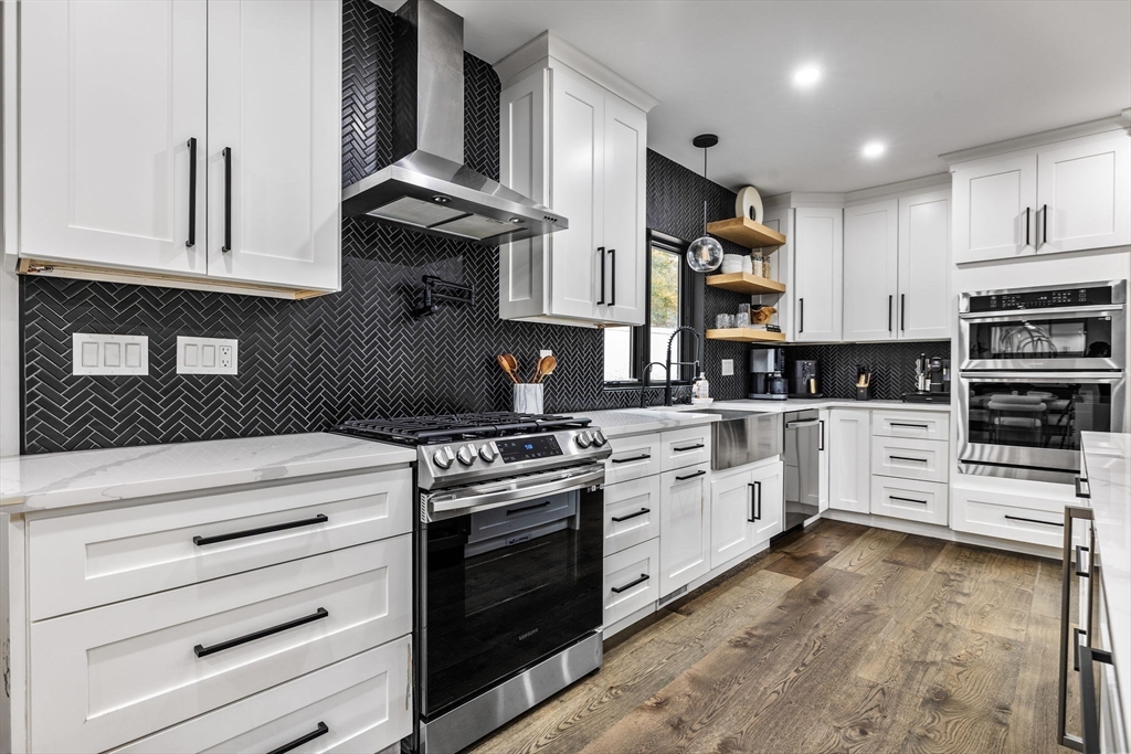 973 Main Street Lynnfield, MA 01940 - Photo 8 of 37 a kitchen with stainless steel appliances granite countertop white cabinets and a stove