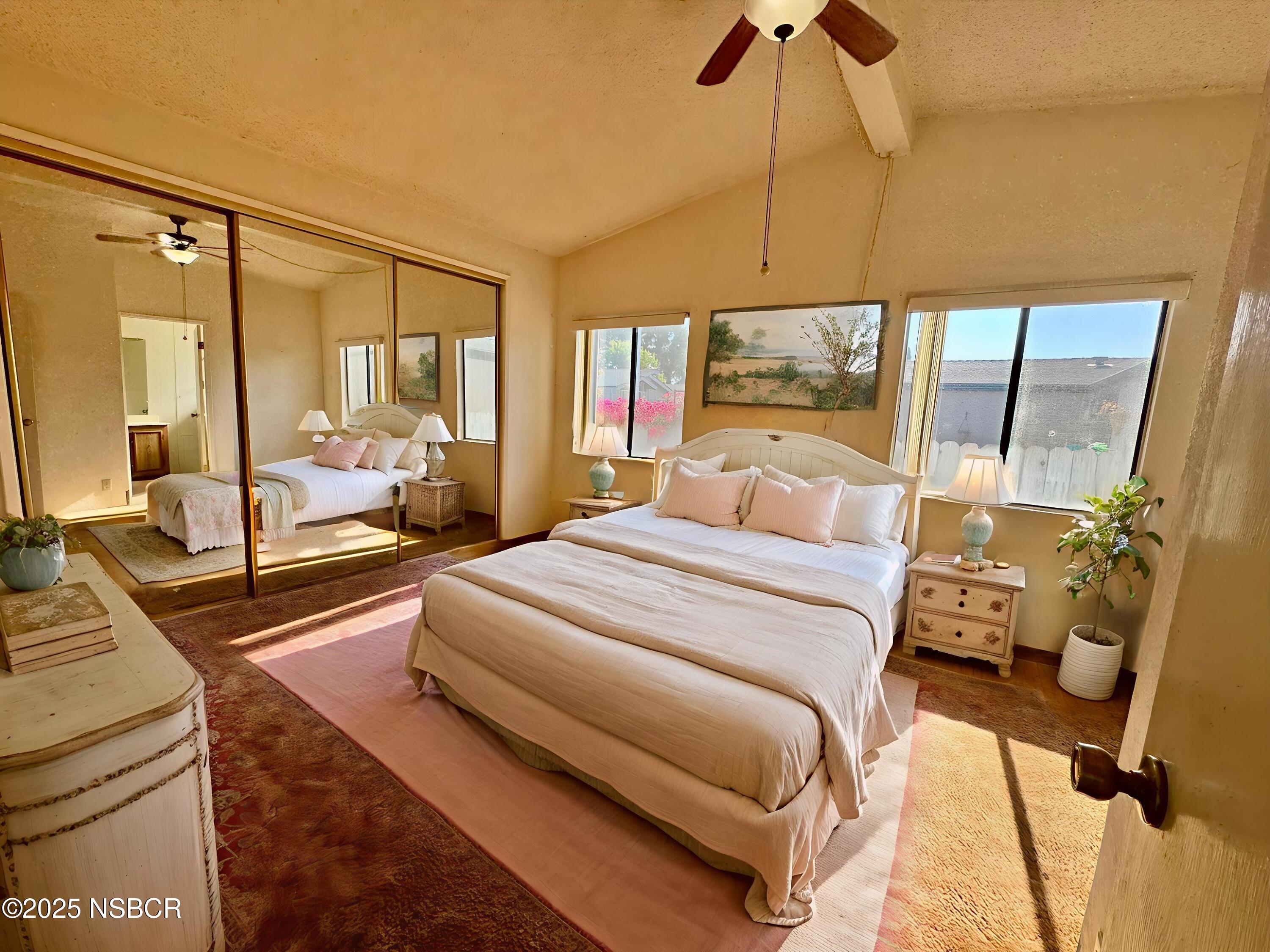 1317 V Street, Unit 58 Lompoc, CA 93436 - Photo 12 of 34 a bedroom with a bed and a chandelier