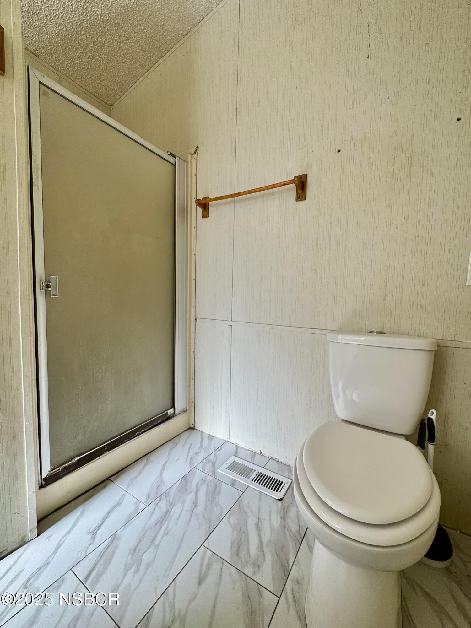 1317 V Street, Unit 58 Lompoc, CA 93436 - Photo 16 of 34 a bathroom with a toilet and a shower
