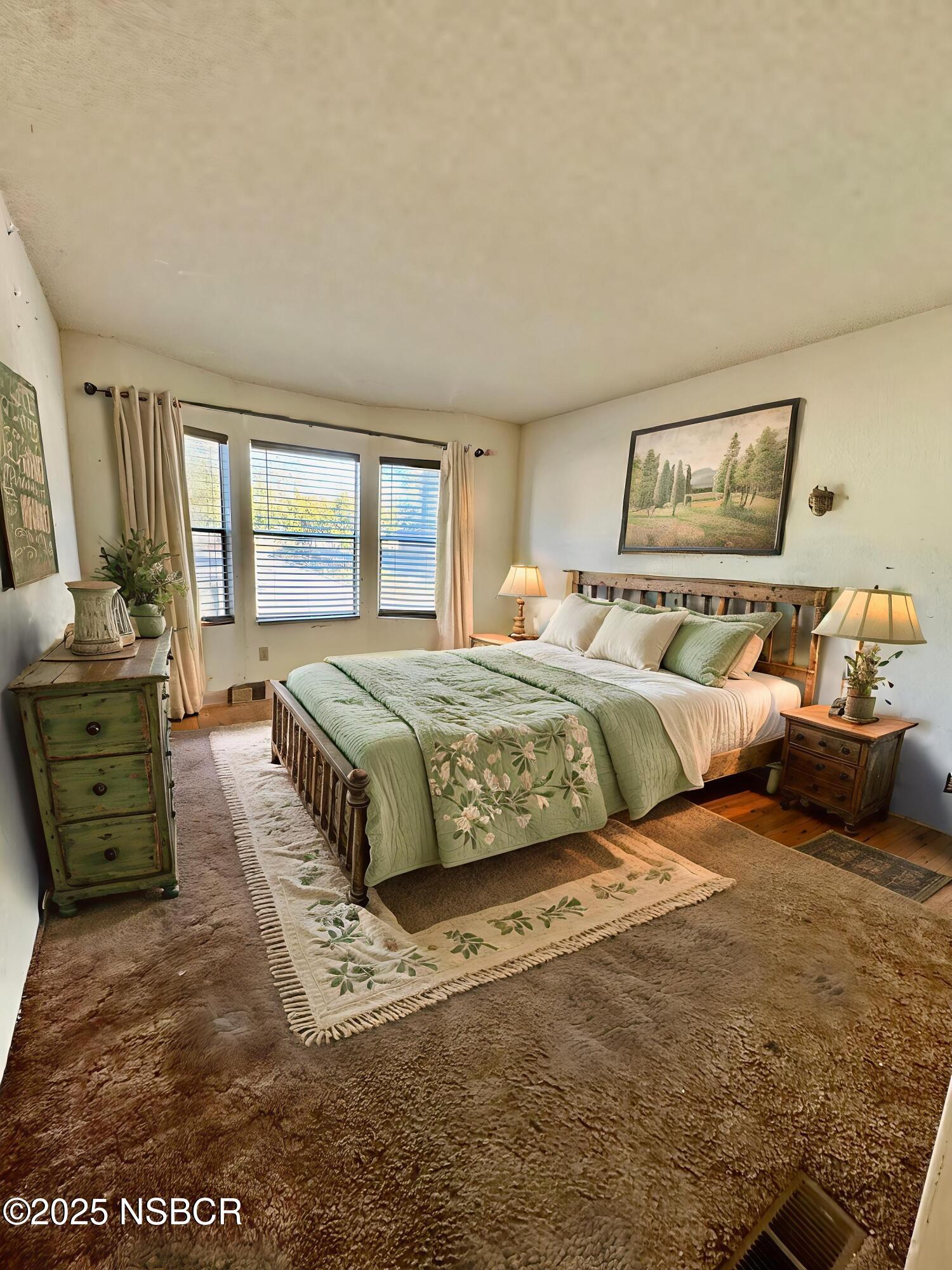 1317 V Street, Unit 58 Lompoc, CA 93436 - Photo 17 of 34 a bedroom with a bed and wooden floor