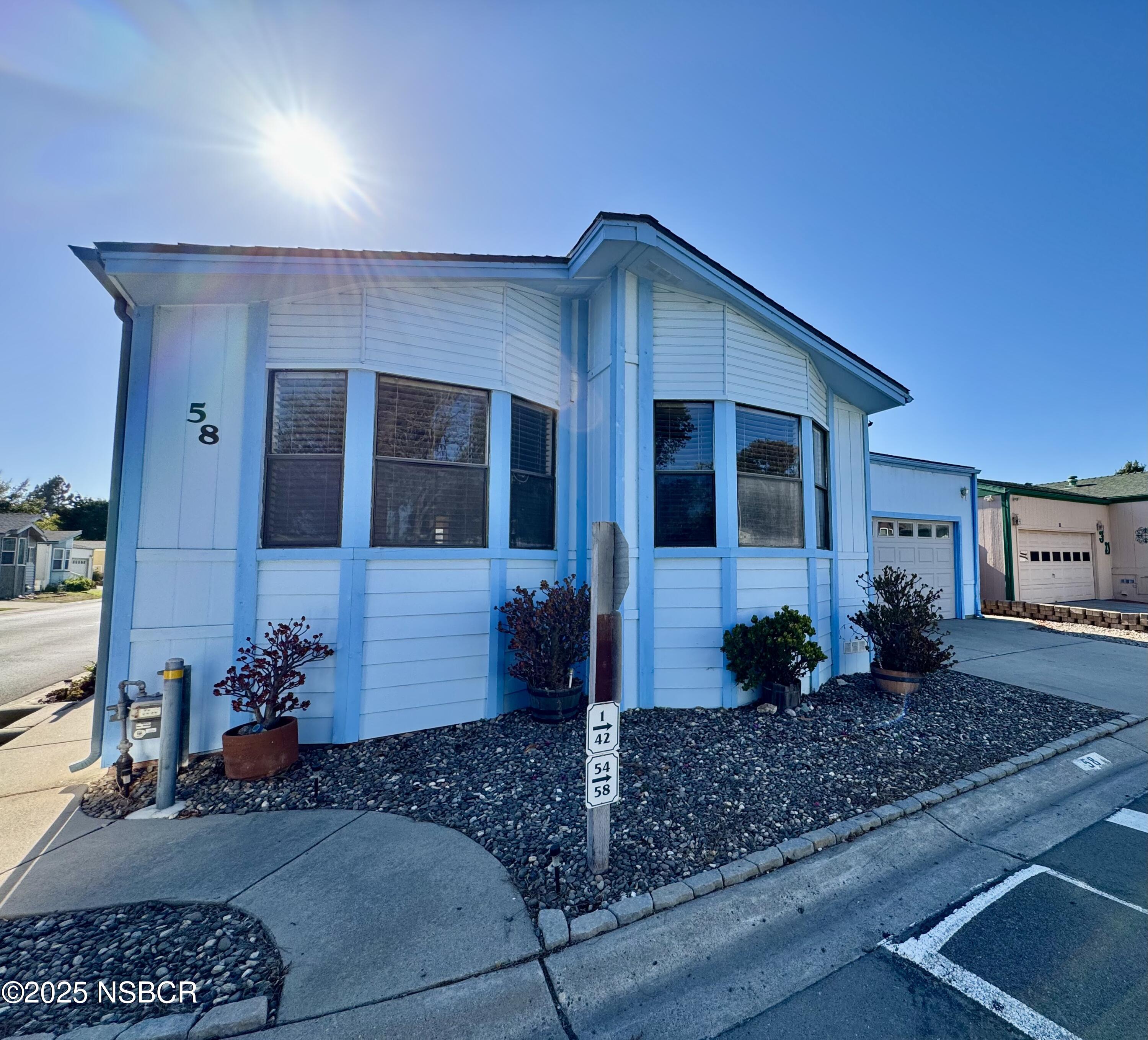 1317 V Street, Unit 58 Lompoc, CA 93436 - Photo 2 of 34 a front view of a house with garden