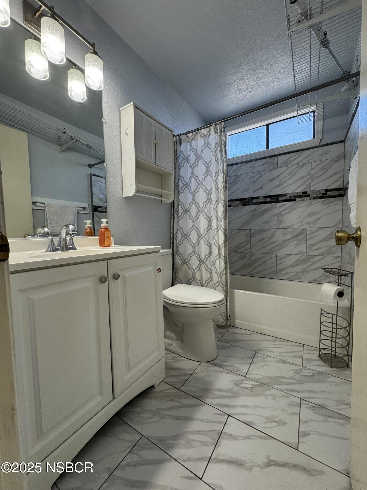 1317 V Street, Unit 58 Lompoc, CA 93436 - Photo 21 of 34 a bathroom with a sink toilet and shower
