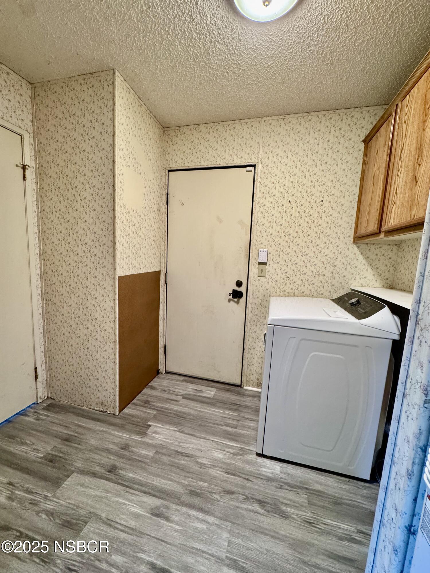 1317 V Street, Unit 58 Lompoc, CA 93436 - Photo 22 of 34 a view of a room with wooden floor washer and dryer