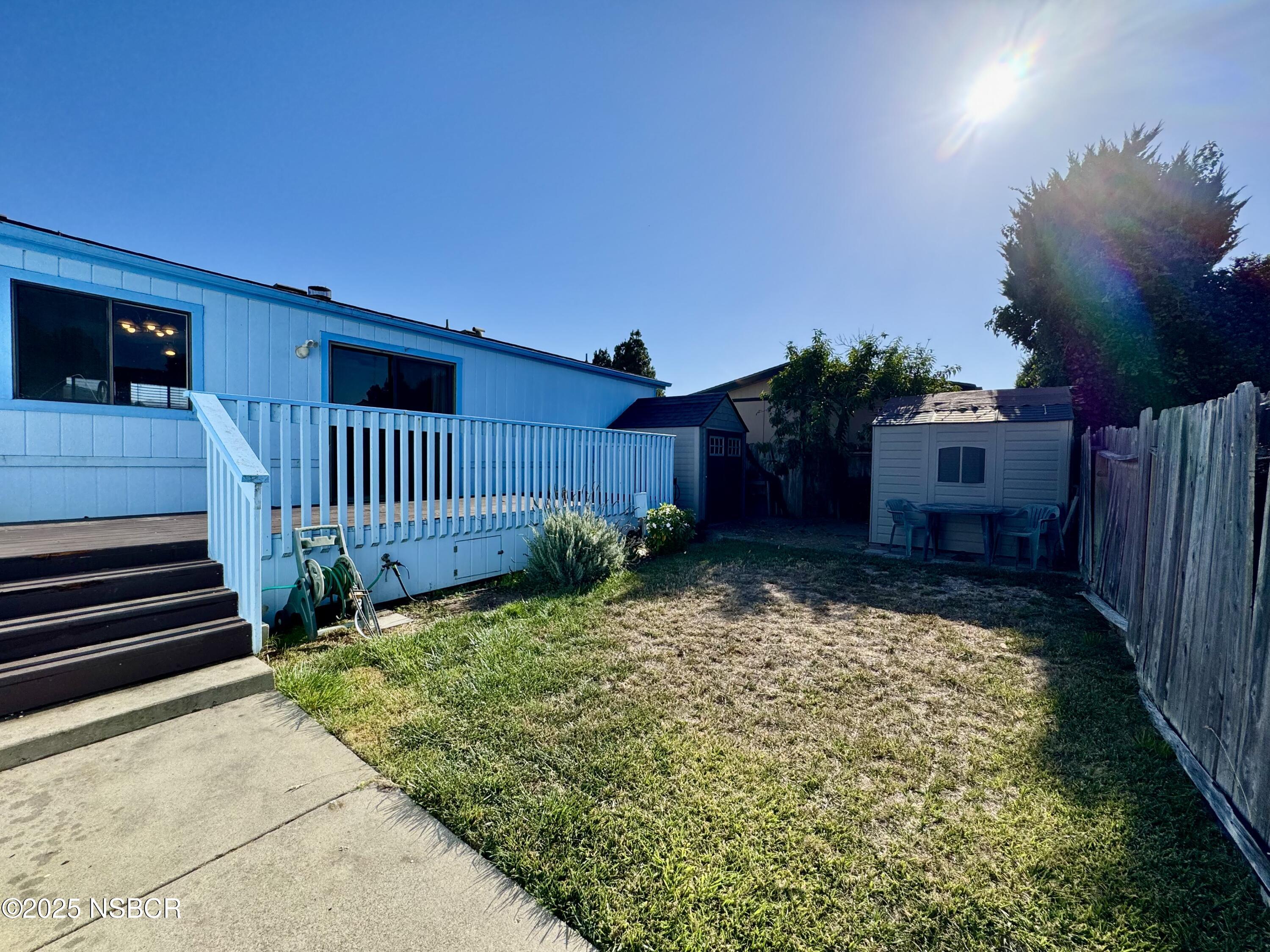 1317 V Street, Unit 58 Lompoc, CA 93436 - Photo 25 of 34 a view of a house with a small yard and wooden fence