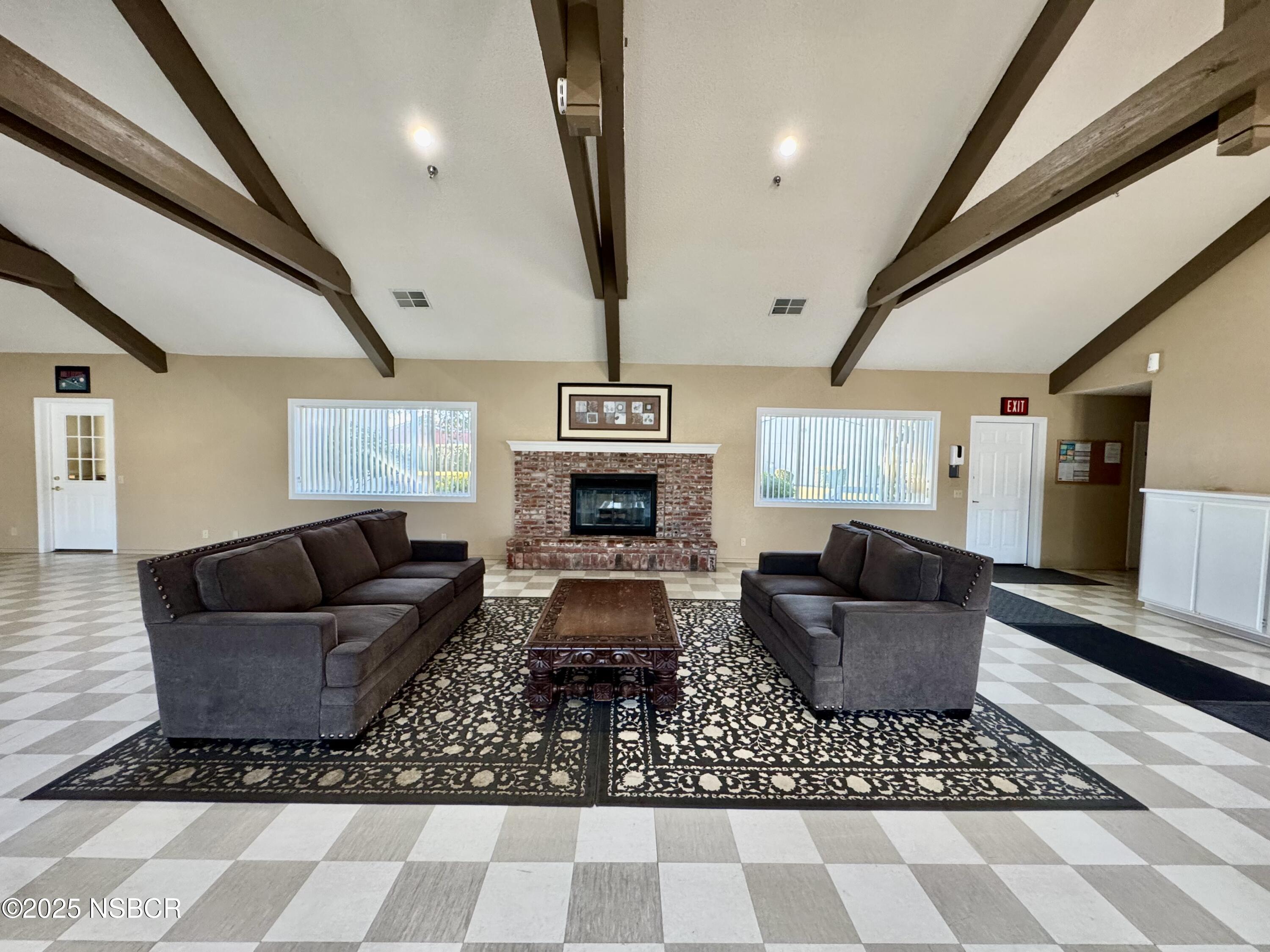 1317 V Street, Unit 58 Lompoc, CA 93436 - Photo 28 of 34 a living room with furniture and a fireplace