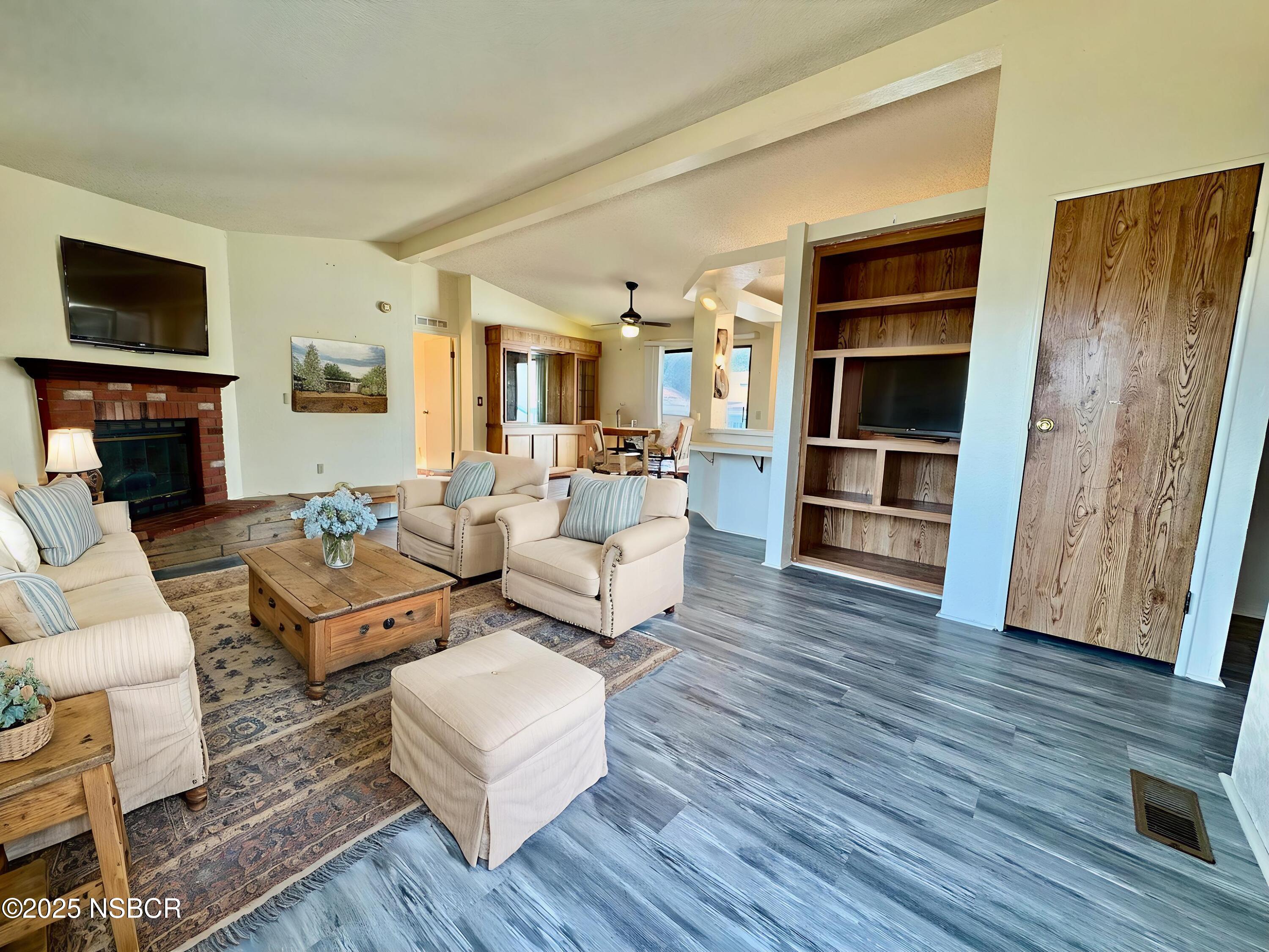1317 V Street, Unit 58 Lompoc, CA 93436 - Photo 6 of 34 a living room with furniture fireplace and wooden floor