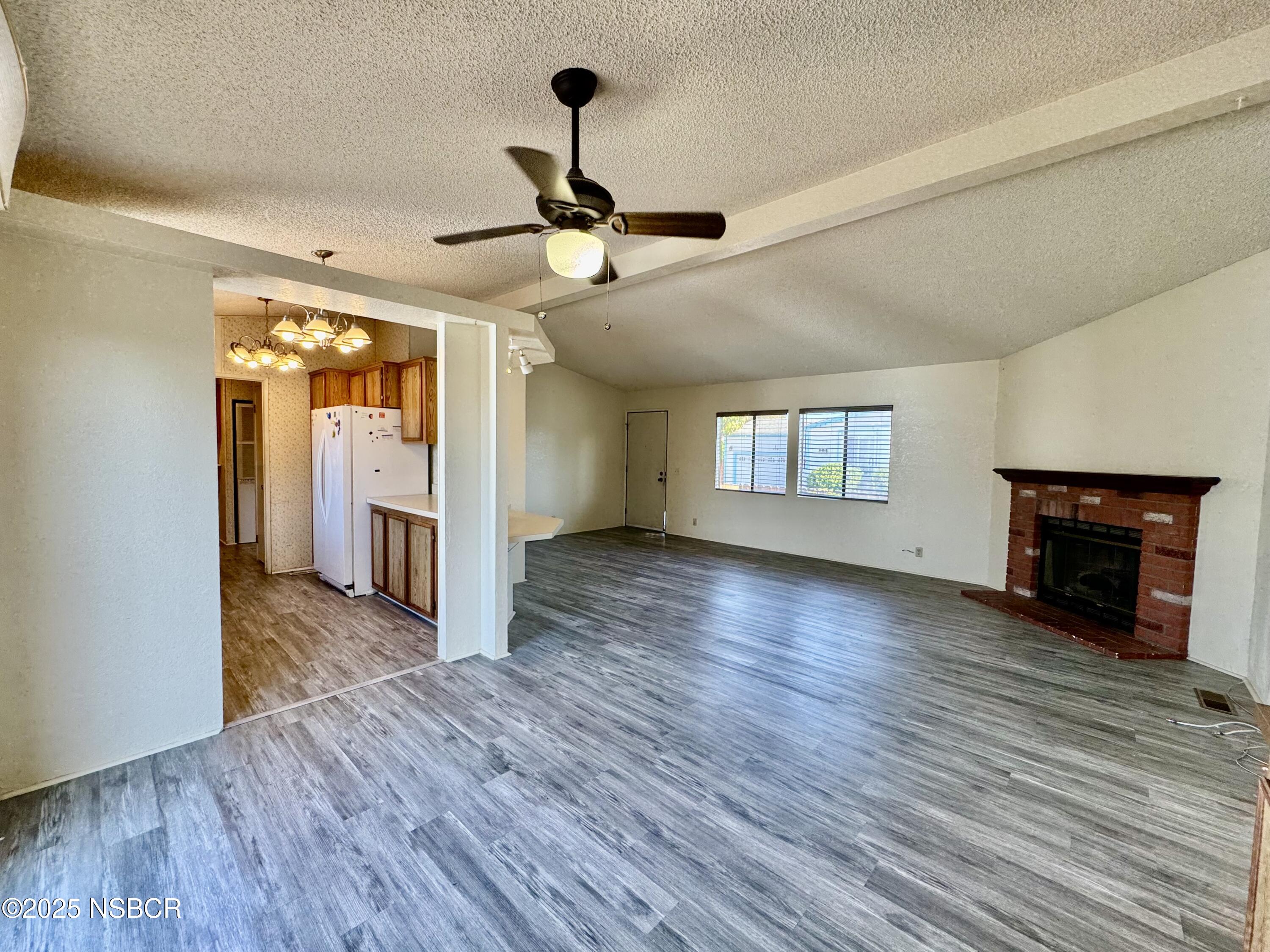 1317 V Street, Unit 58 Lompoc, CA 93436 - Photo 8 of 34 a view of an empty room with window and wooden floor