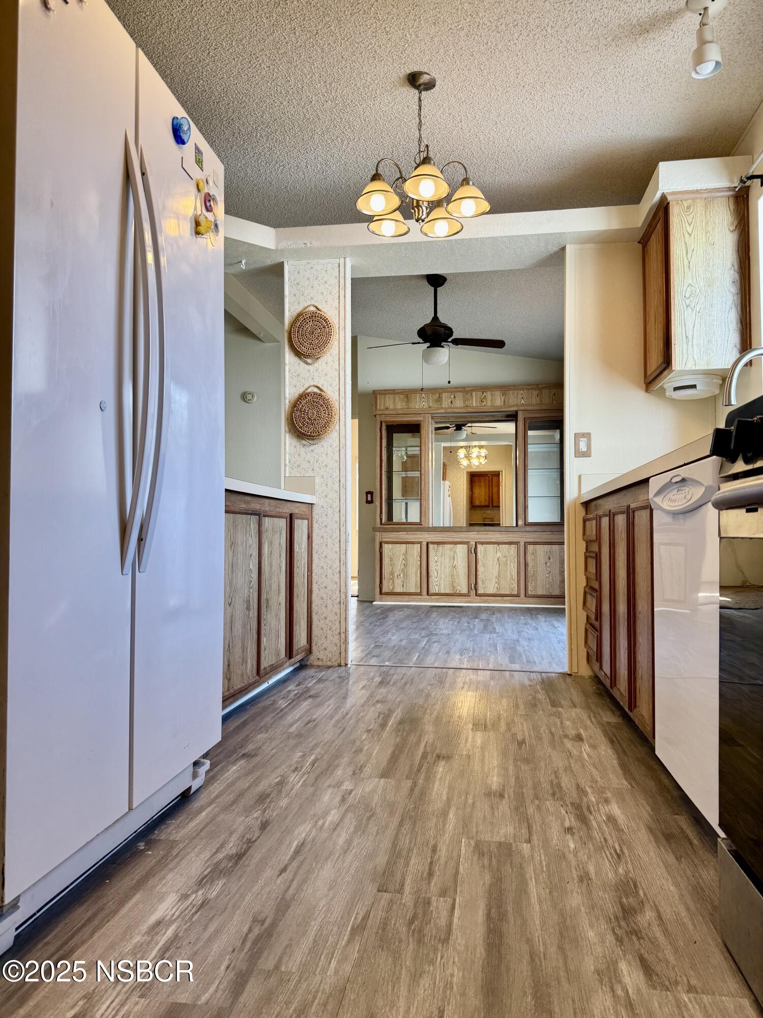 1317 V Street, Unit 58 Lompoc, CA 93436 - Photo 10 of 34 a view of a kitchen with a sink and refrigerator
