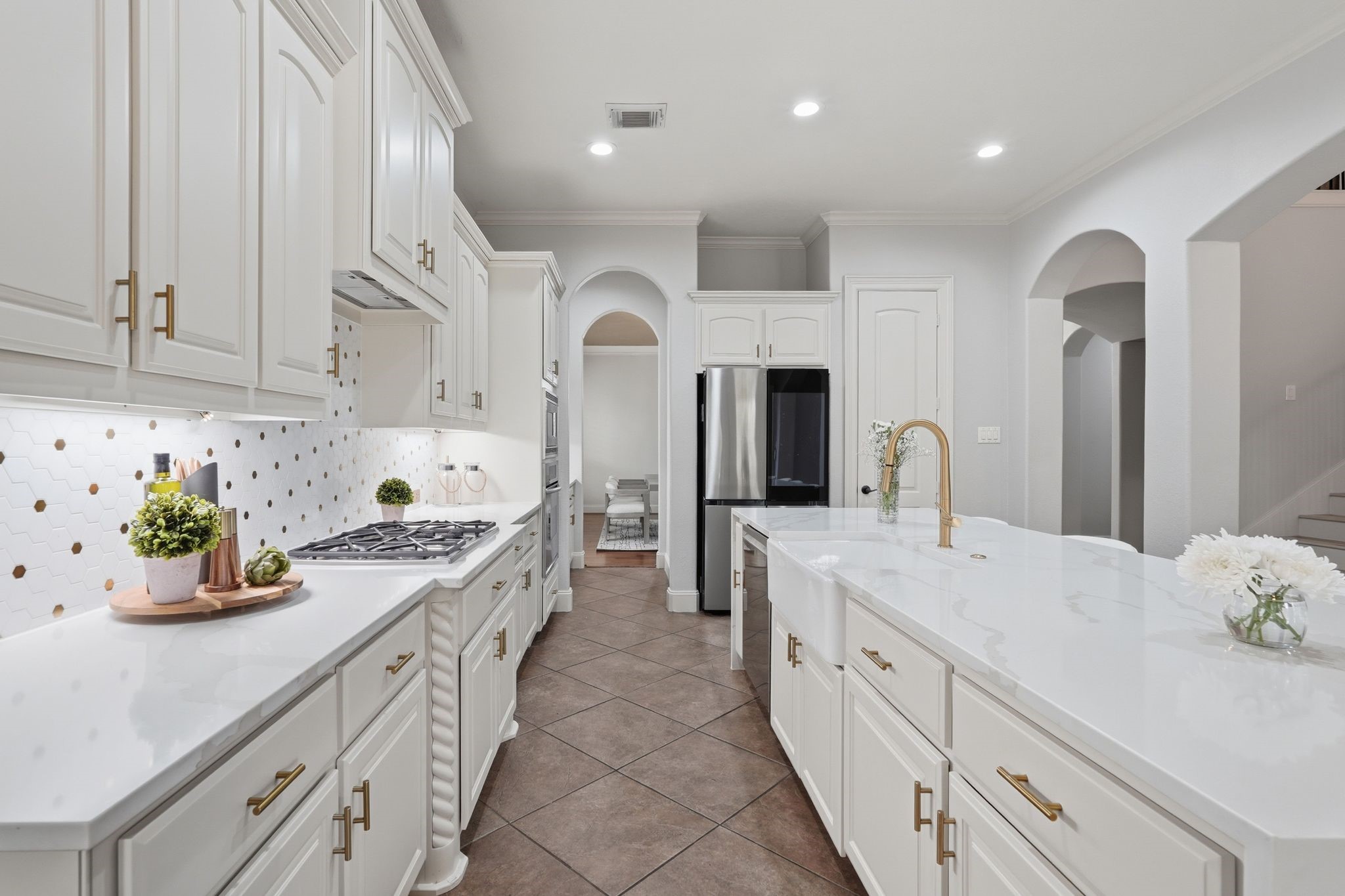 7603 Hogan Bridge Court Spring, TX 77389 - Photo 14 of 50 Sleek kitchen equipped with a gas cooktop and stainless-steel appliances.