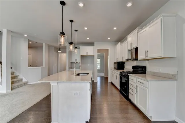 a view of a kitchen with marble kitchen and stainless steel appliances