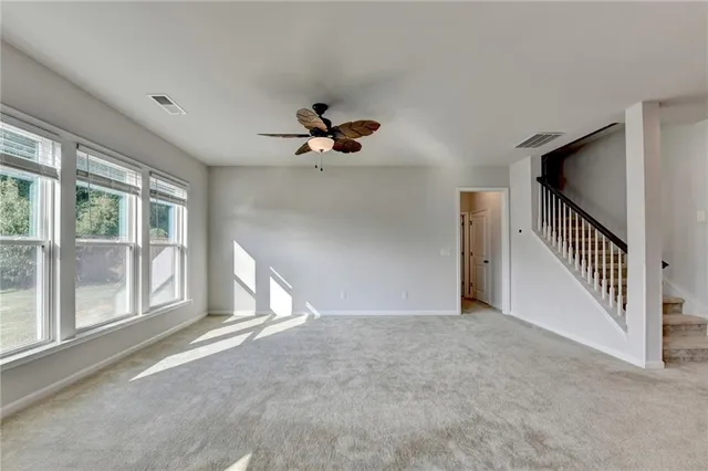 an empty room with fan and window