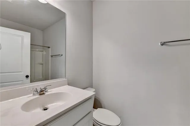 a view of an empty room with window and chandelier fan