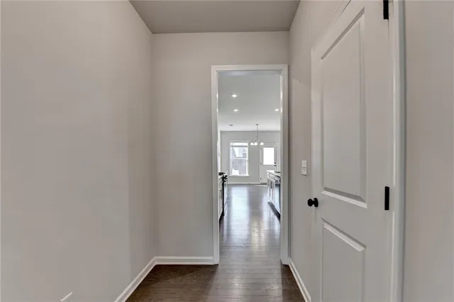 a view of white cabinets and wooden floor
