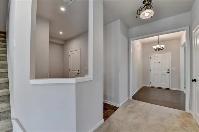 a kitchen with white cabinets and sink